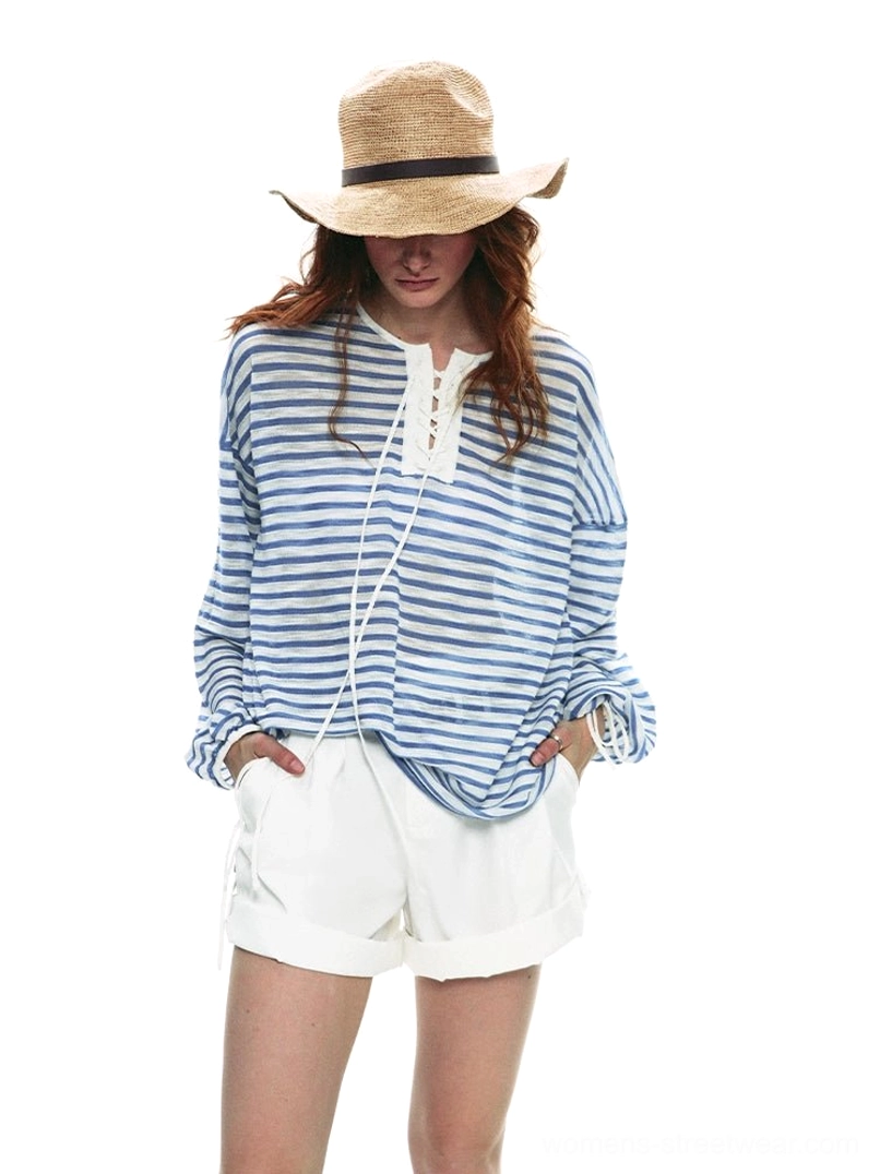 Sky blue and white nautical lace-up striped long sleeve top styled with white shorts and straw sun hat front view