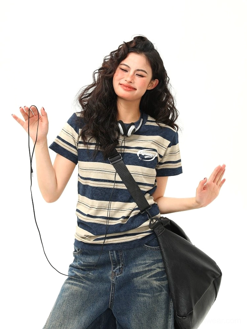 Women’s navy beige vintage stripe cotton streetwear tee front view styled with wide-leg denim and black crossbody bag