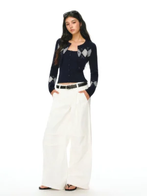 Navy blue argyle cropped knit cardigan and matching camisole set styled with white wide leg trousers and leather belt