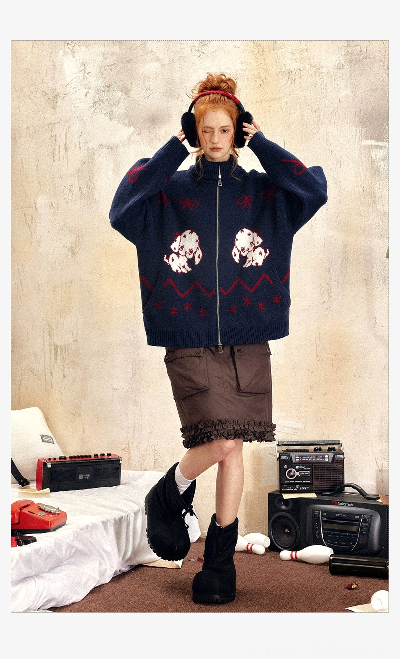 Navy blue oversized Dalmatian puppy print sweater with red decorative motifs and high zip collar styled with brown ruffled skirt and boots