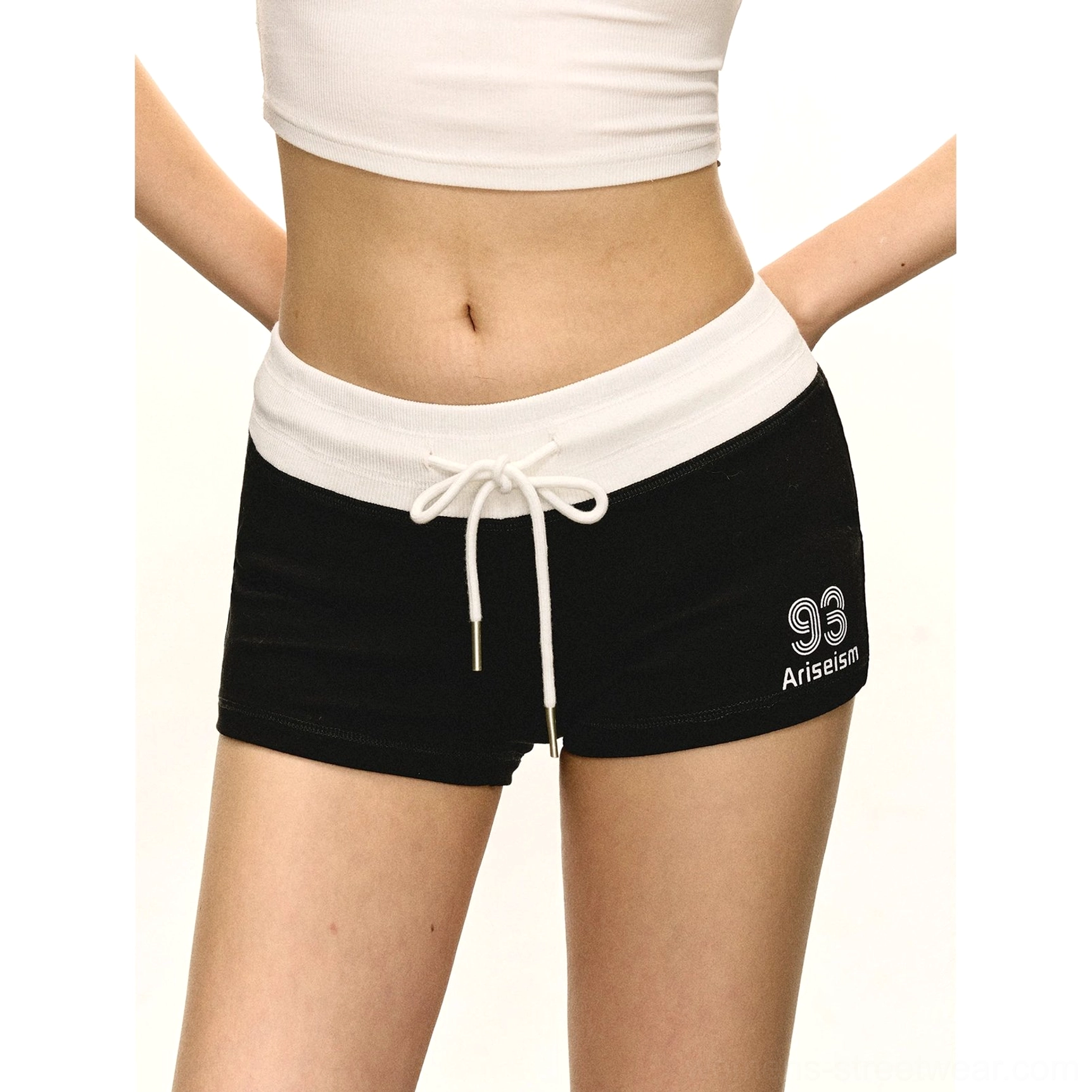 Medium close-up of navy blue low-rise athletic shorts with white contrast waistband tied drawstring and soft stretch fabric