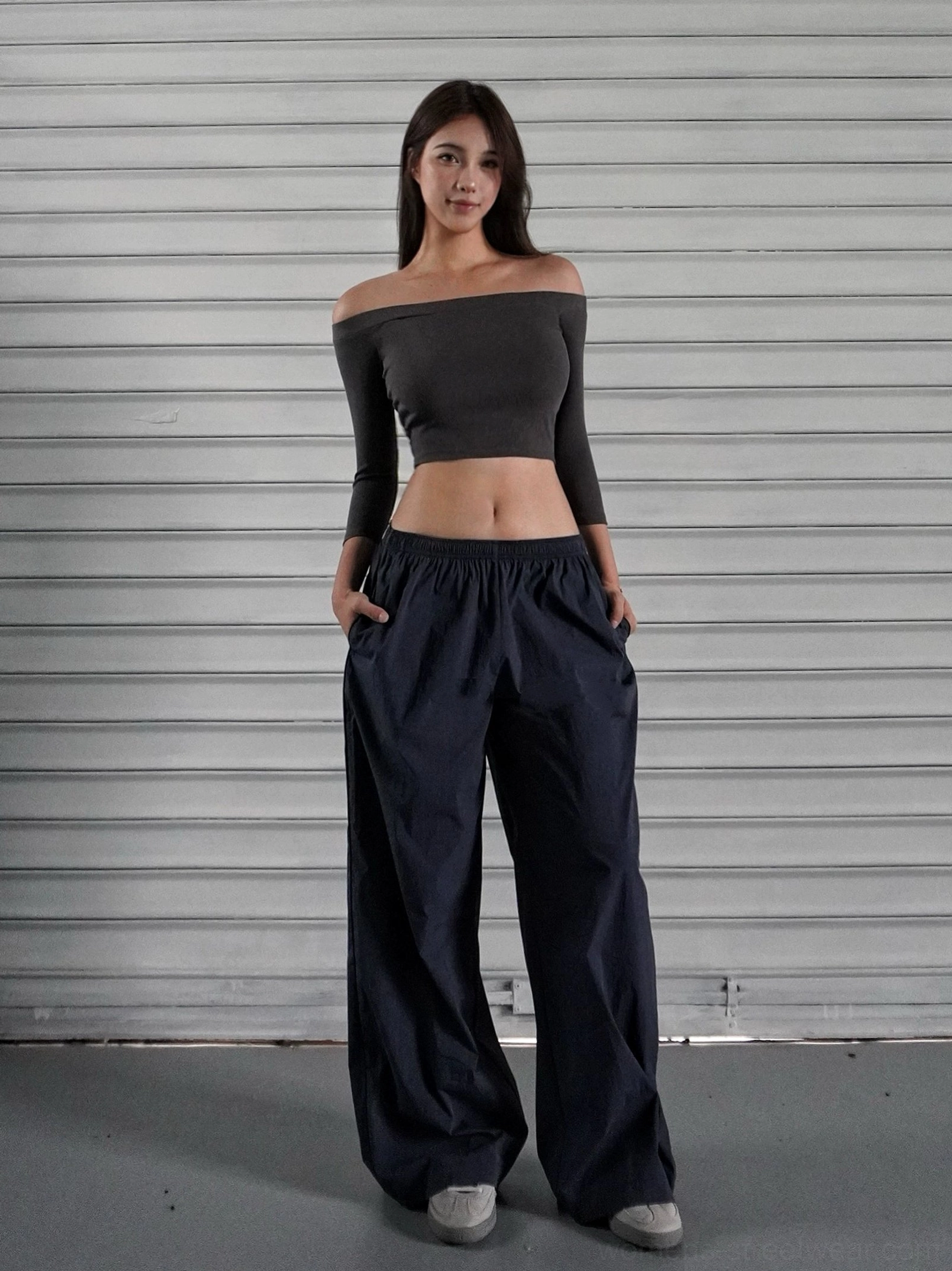Navy blue low-rise wide-leg streetwear cargo pants with an off-shoulder cropped long-sleeve top