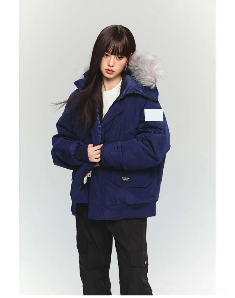 Front view of a navy blue oversized faux fur hooded parka jacket with utility pockets and relaxed Korean streetwear fit