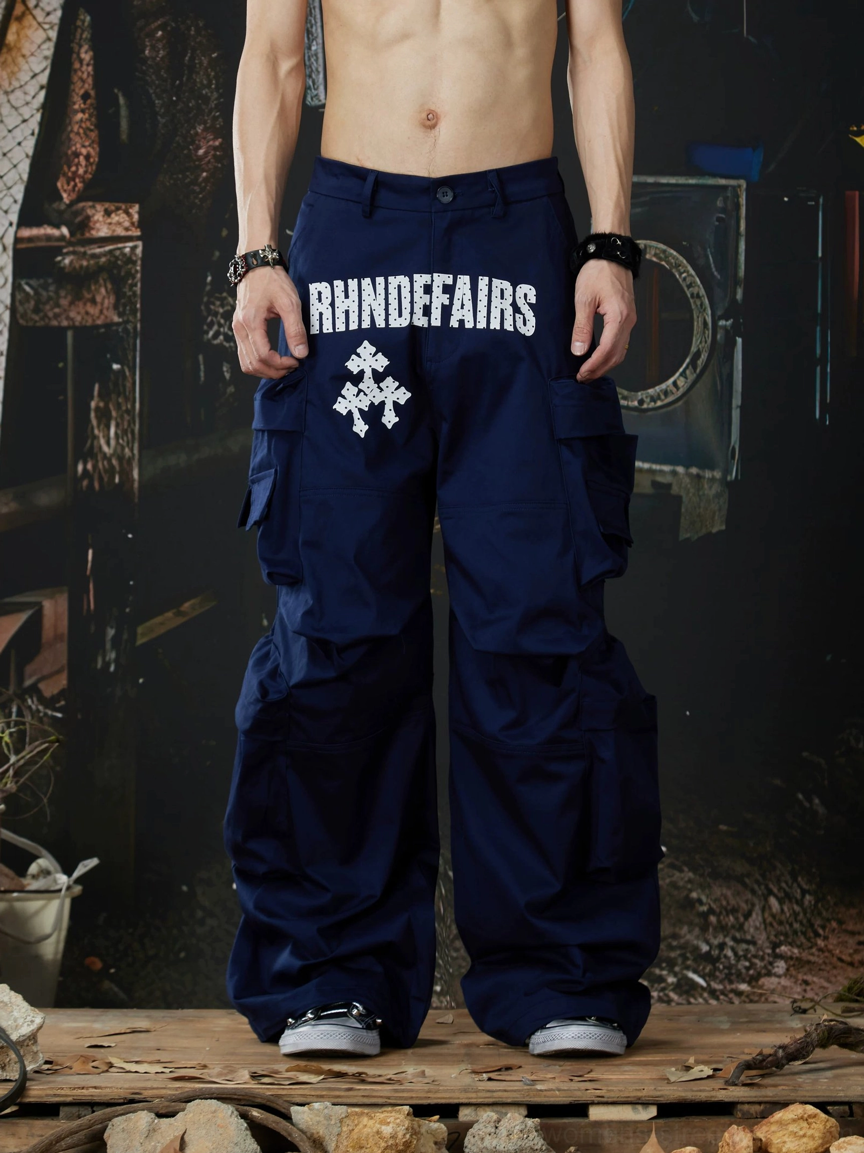 Navy blue oversized multi-pocket cargo pants front full-body view with wide-leg streetwear fit and hip graphic