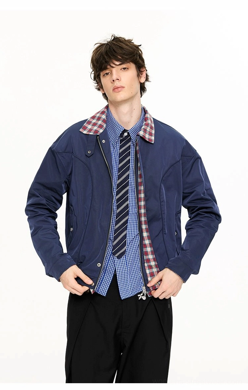 Full front view of navy blue plaid-lined Harrington jacket with stand collar snap details and relaxed cropped silhouette