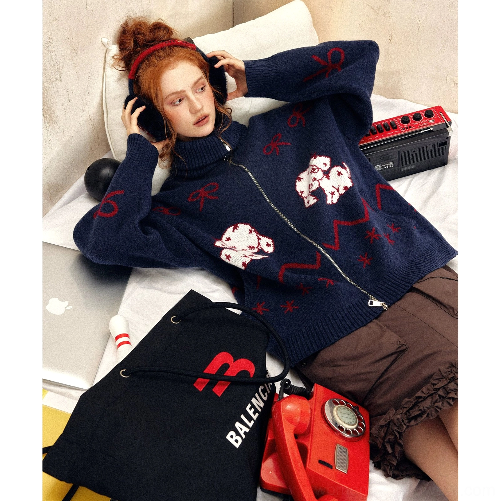 Navy blue oversized puppy print knit sweater shown from above with high zip collar, red jacquard motifs, and cozy vintage bedroom styling