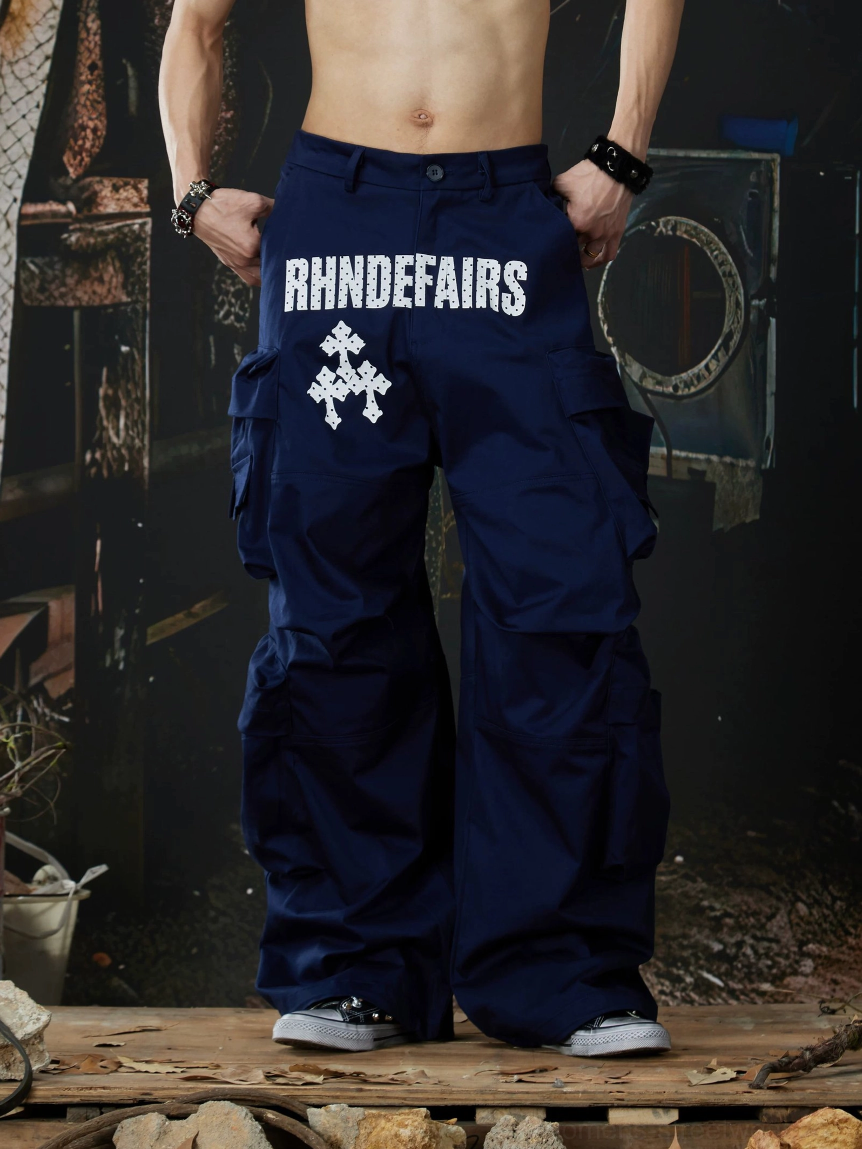 Navy blue stacked pocket wide-leg streetwear cargo pants front view showing contrast graphic waist detail and baggy fit