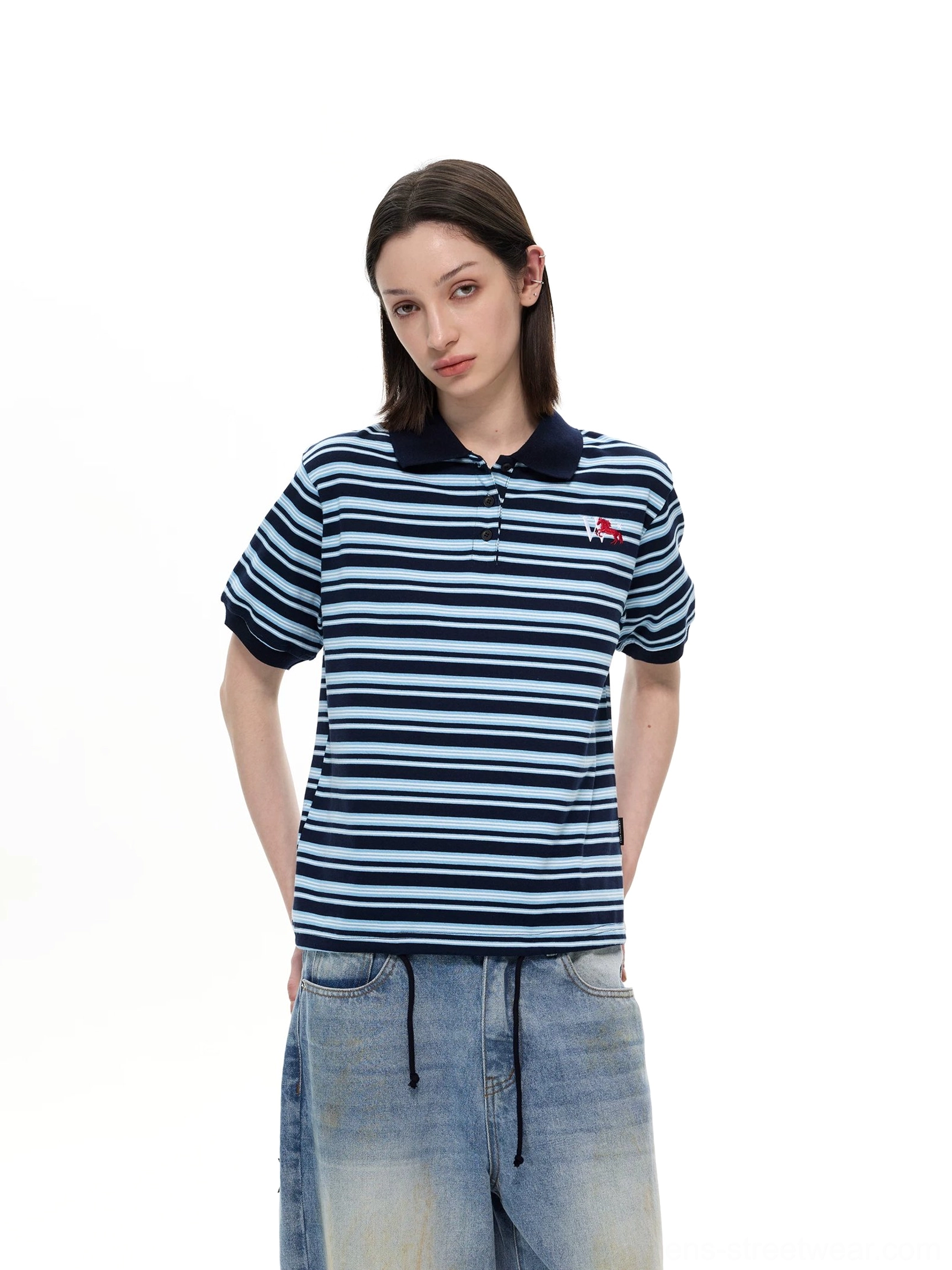 Female model wearing navy blue striped retro polo shirt with embroidered chest detail front view
