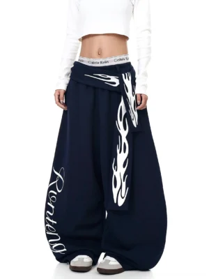 Dark navy oversized streetwear fleece sweatpants with white flame print, script leg detail, and detachable waist sash