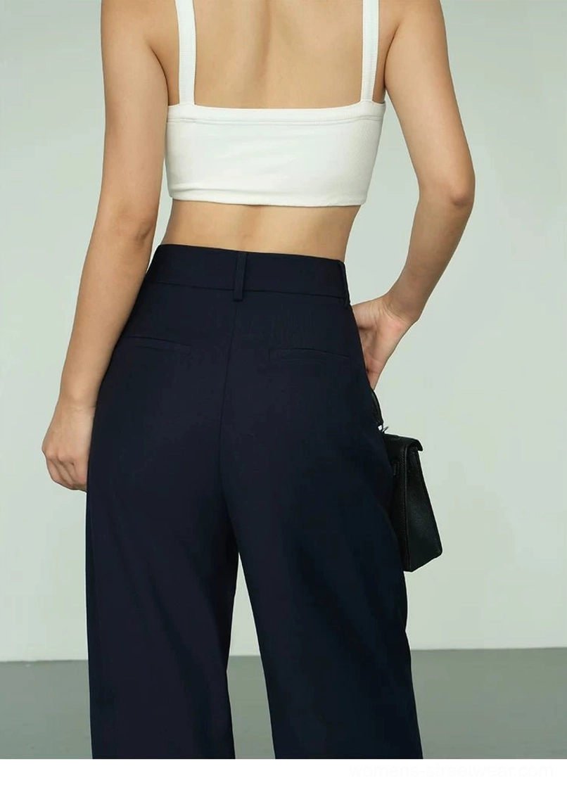 Back view of deep navy high-waist wide-leg streetwear trousers with belt loops and concealed zip closure