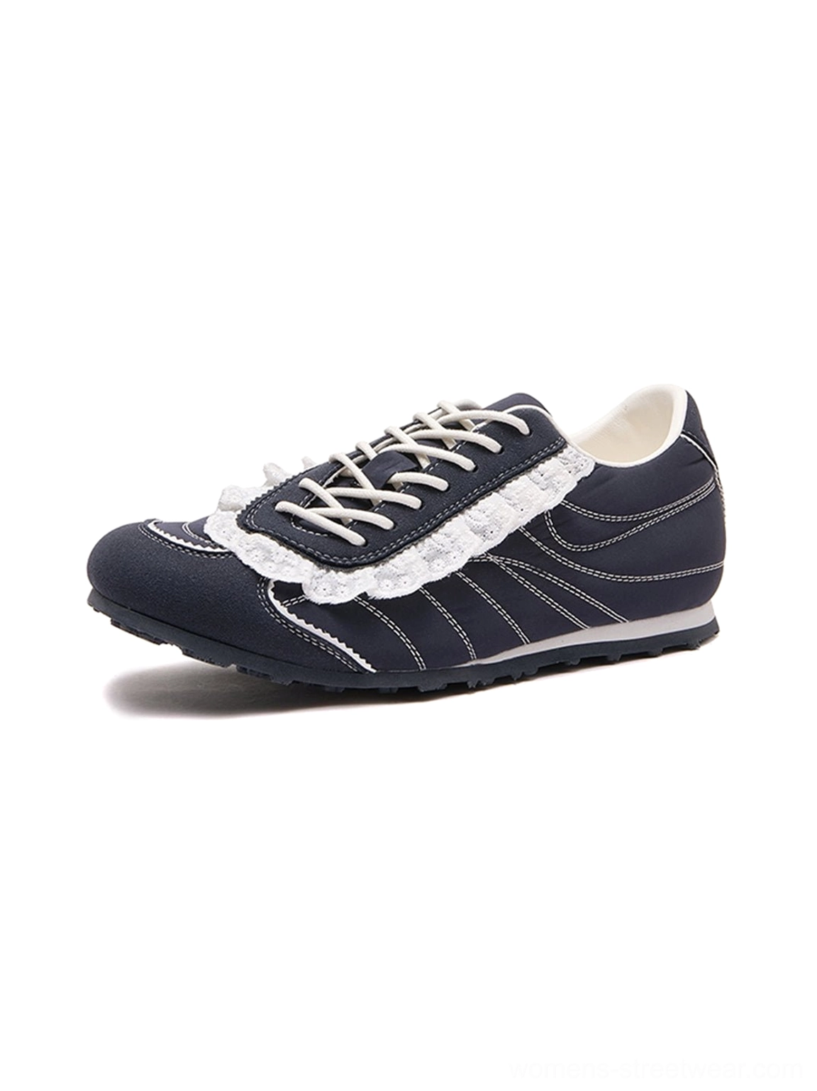 Right side profile of a navy low-top trainer with white contrast stitching and decorative ruffled lace trim