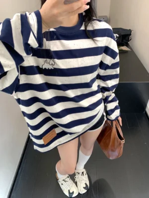 Close-up of navy and oatmeal speckled stripe oversized long sleeve tee with puppy chest embroidery
