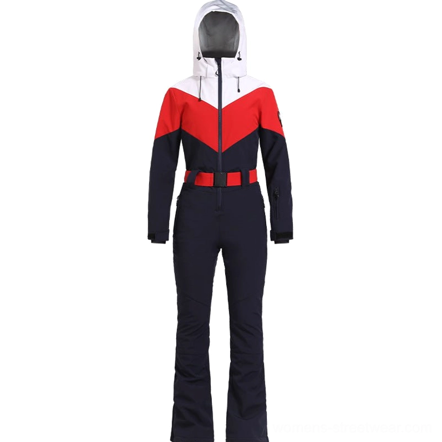 Navy red white women's hooded colorblock ski jumpsuit displayed from the front with flared navy pants and red adjustable waist belt