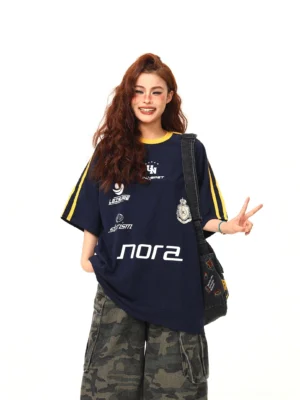 Navy retro sporty graphic oversized streetwear tee front full body view styled with camouflage cargo pants and crossbody bag