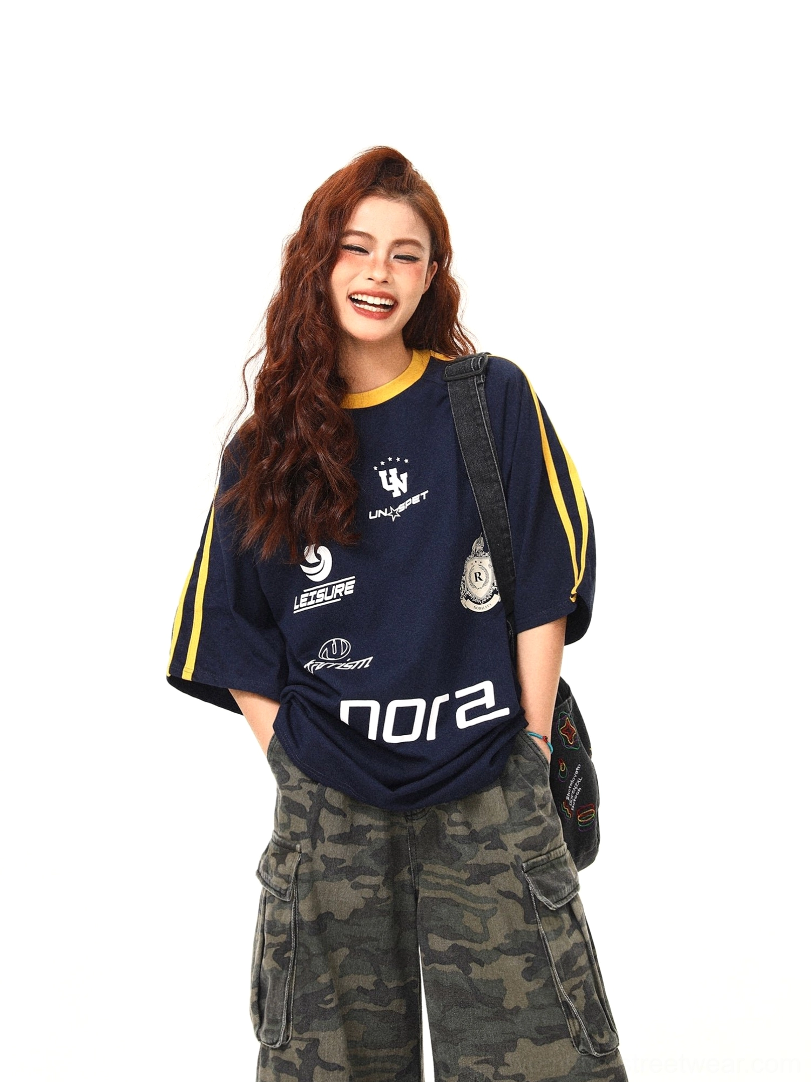 Close front view of navy retro sporty oversized tee showing yellow ribbed crew neck shoulder stripes and graphic print