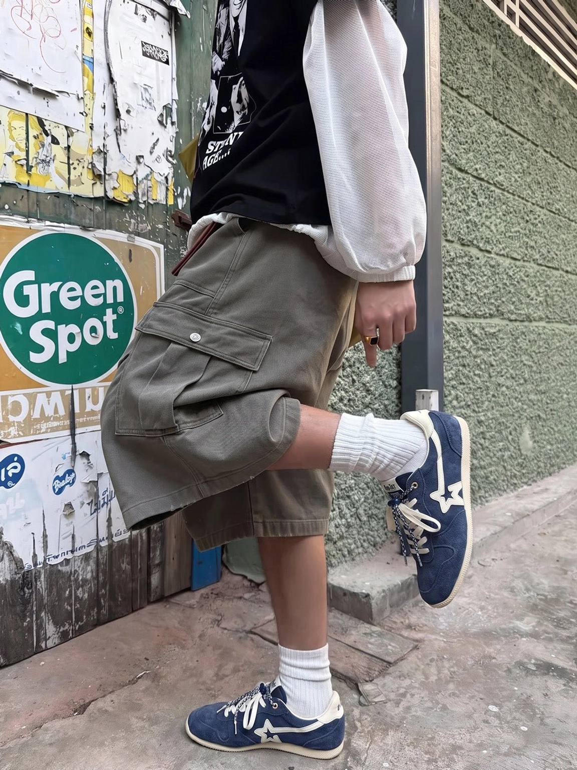 Navy low-profile retro streetwear sneakers styled with cargo shorts and white crew socks in an outdoor urban setting
