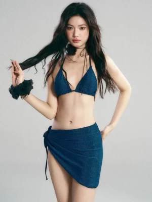 Side-front view of navy blue shimmer halter bikini and asymmetric sarong skirt Y2K swimwear set