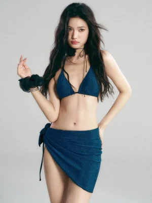 Navy shimmer halter triangle bikini set with matching tie-side sarong skirt front close-up on model