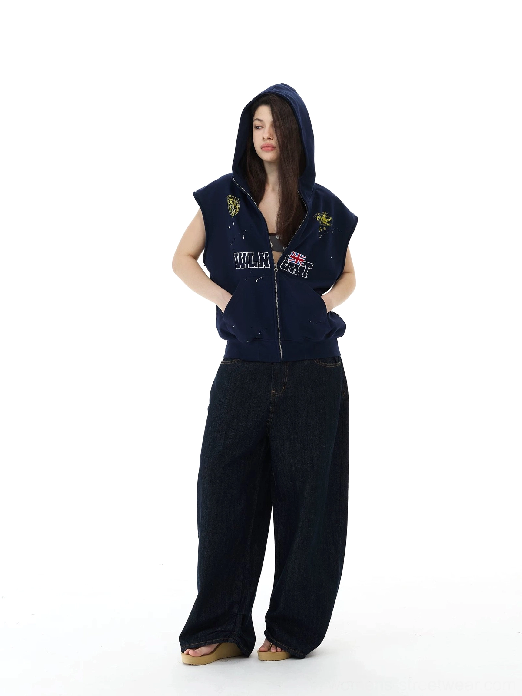 Side view of relaxed navy sleeveless hoodie vest styled with wide-leg dark denim jeans for Korean streetwear
