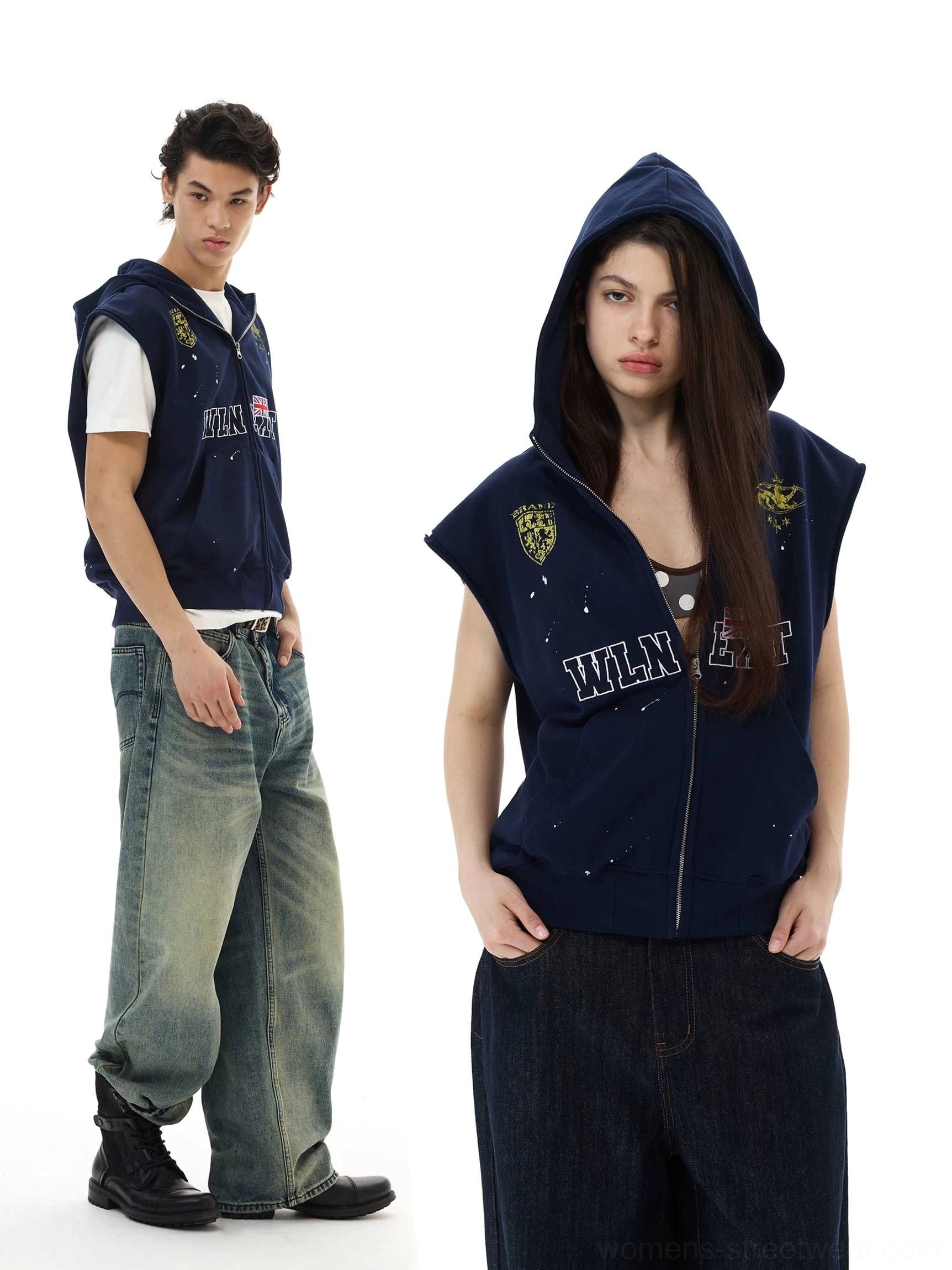 Navy sleeveless zip hoodie vest shown on two models with crest graphics, flag details, denim styling, and leather boots