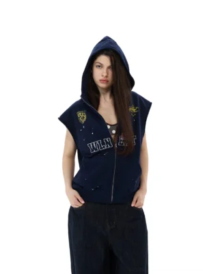 Close-up of navy sleeveless zip-up hoodie vest with hood up and vintage paint-splatter streetwear details