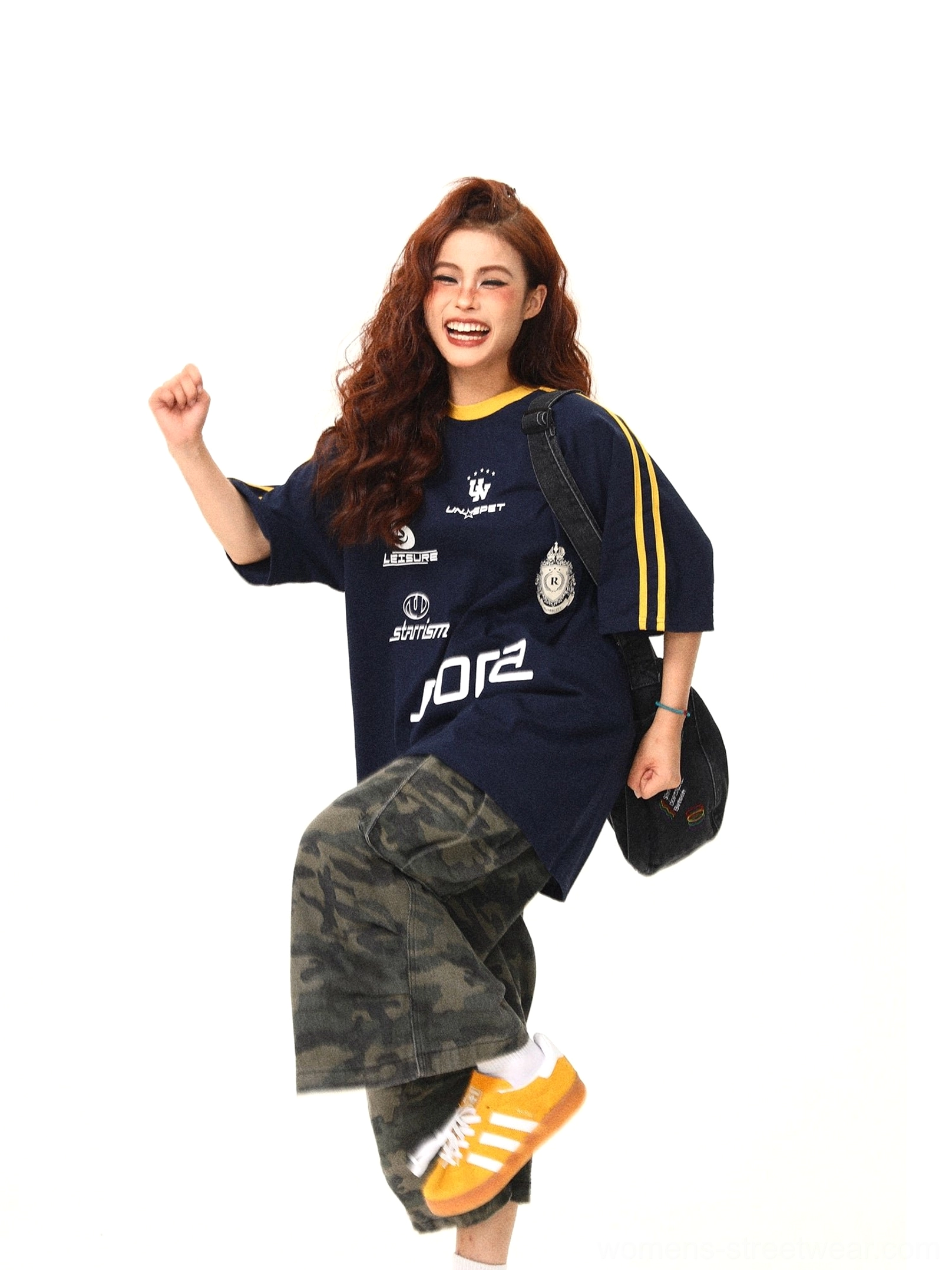 Navy sporty streetwear graphic tee with bold front lettering retro badge prints and yellow striped sleeves
