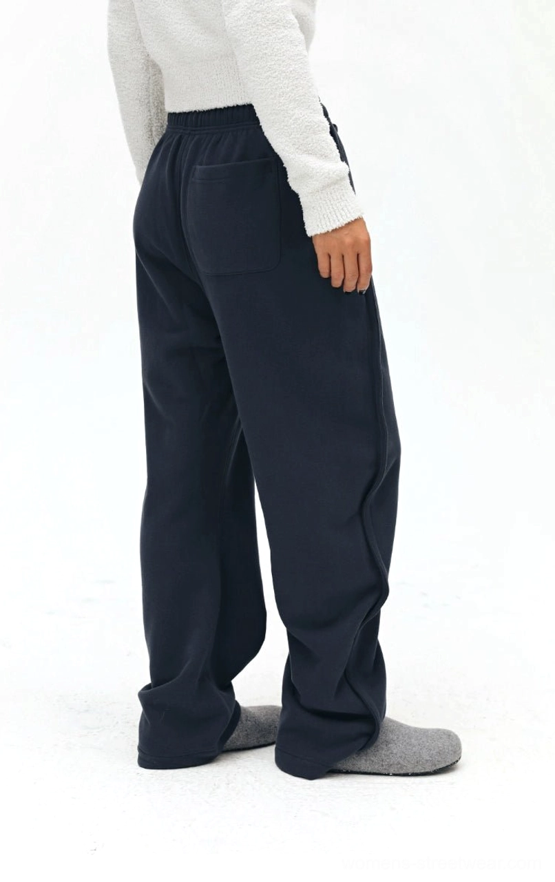 Navy sweatpants back three-quarter view - back patch pocket with soft fleece texture and elasticated waistband