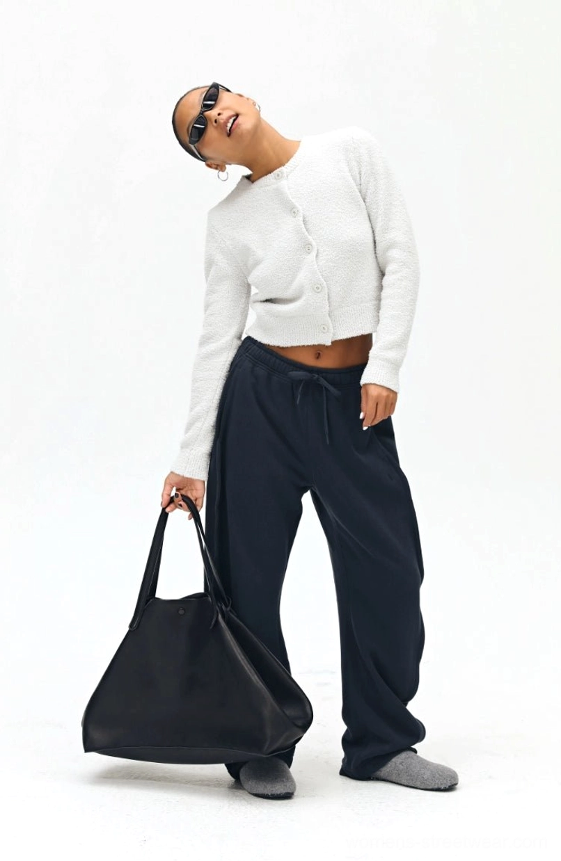 Navy drawstring sweatpants three-quarter front view - wide leg relaxed fit paired with casual accessories