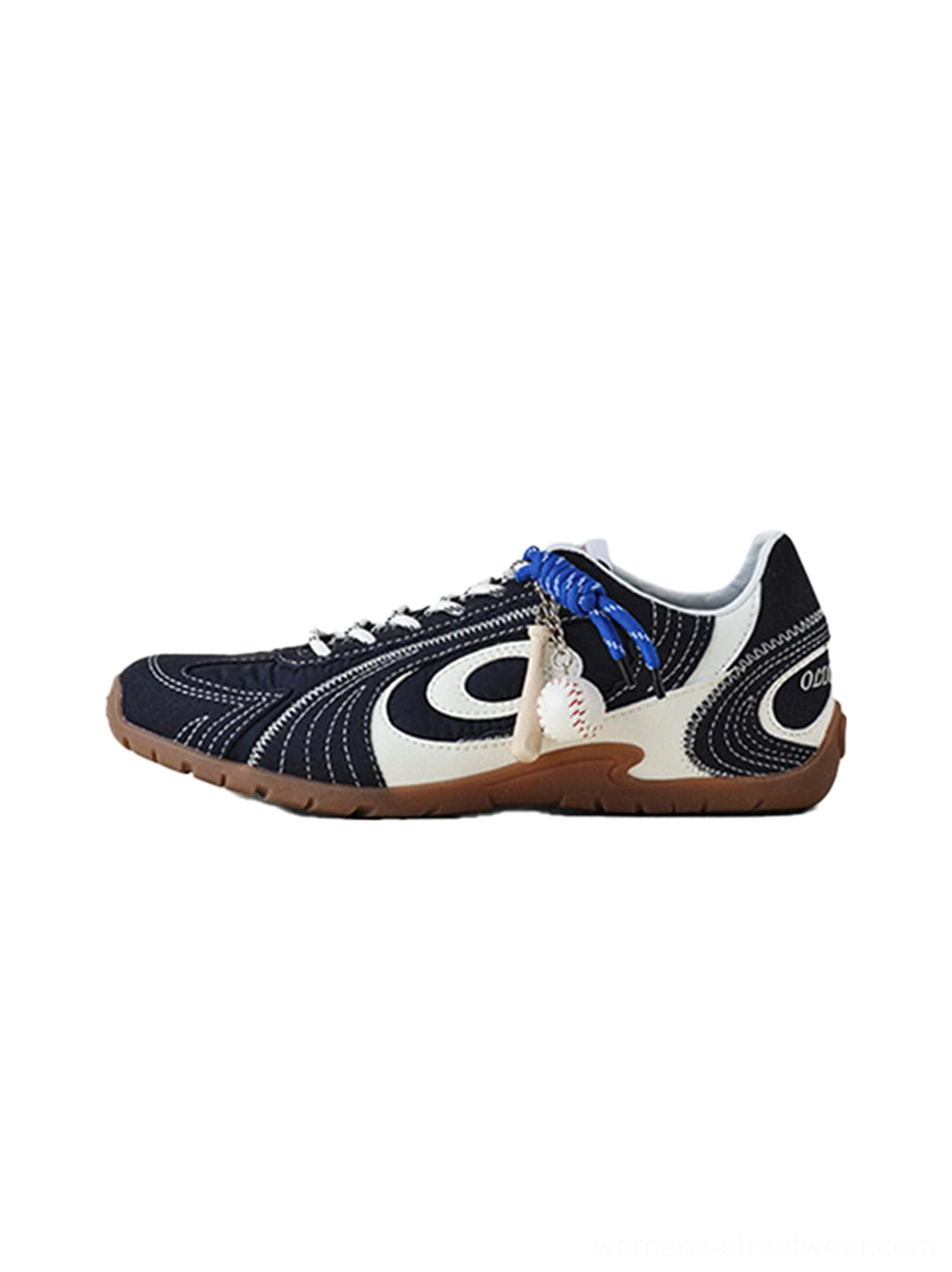 Navy swirl-panel low-profile trainers with cream white overlays, cobalt blue laces, baseball pendant, and gum rubber sole