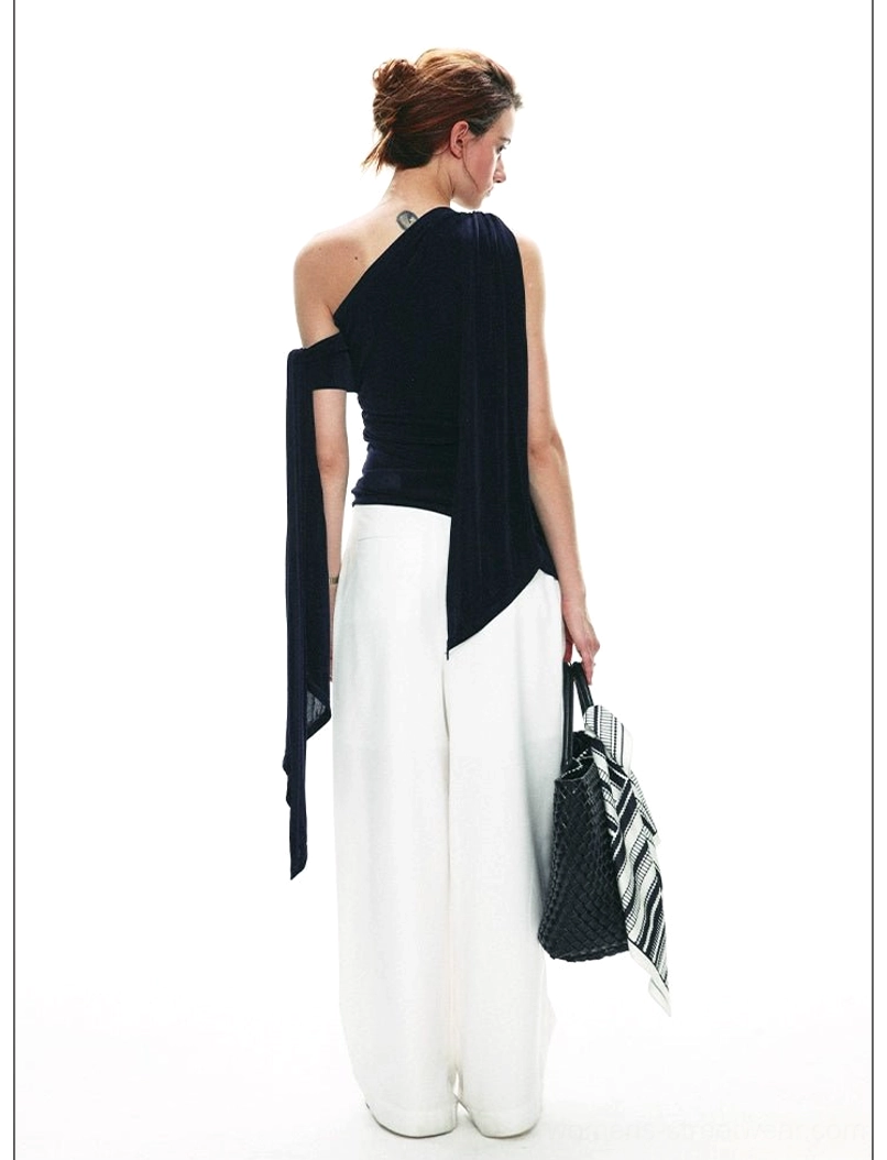 Back view of a navy velvet asymmetric one-shoulder top showing the draped back detail and fitted silhouette
