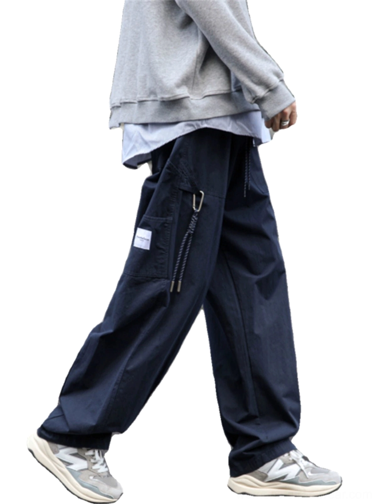 Navy wide-leg streetwear cargo pants shown from the front side with oversized utility pocket, drawstring accent, relaxed drape, gray hoodie, and retro sneakers