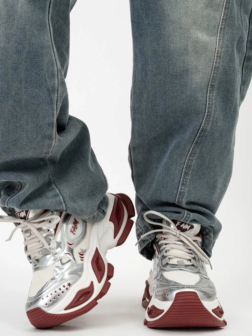 Futuristic silver platform sneakers with vibrant red heel accents, maroon outsole details, metallic overlays, and chunky streetwear silhouette