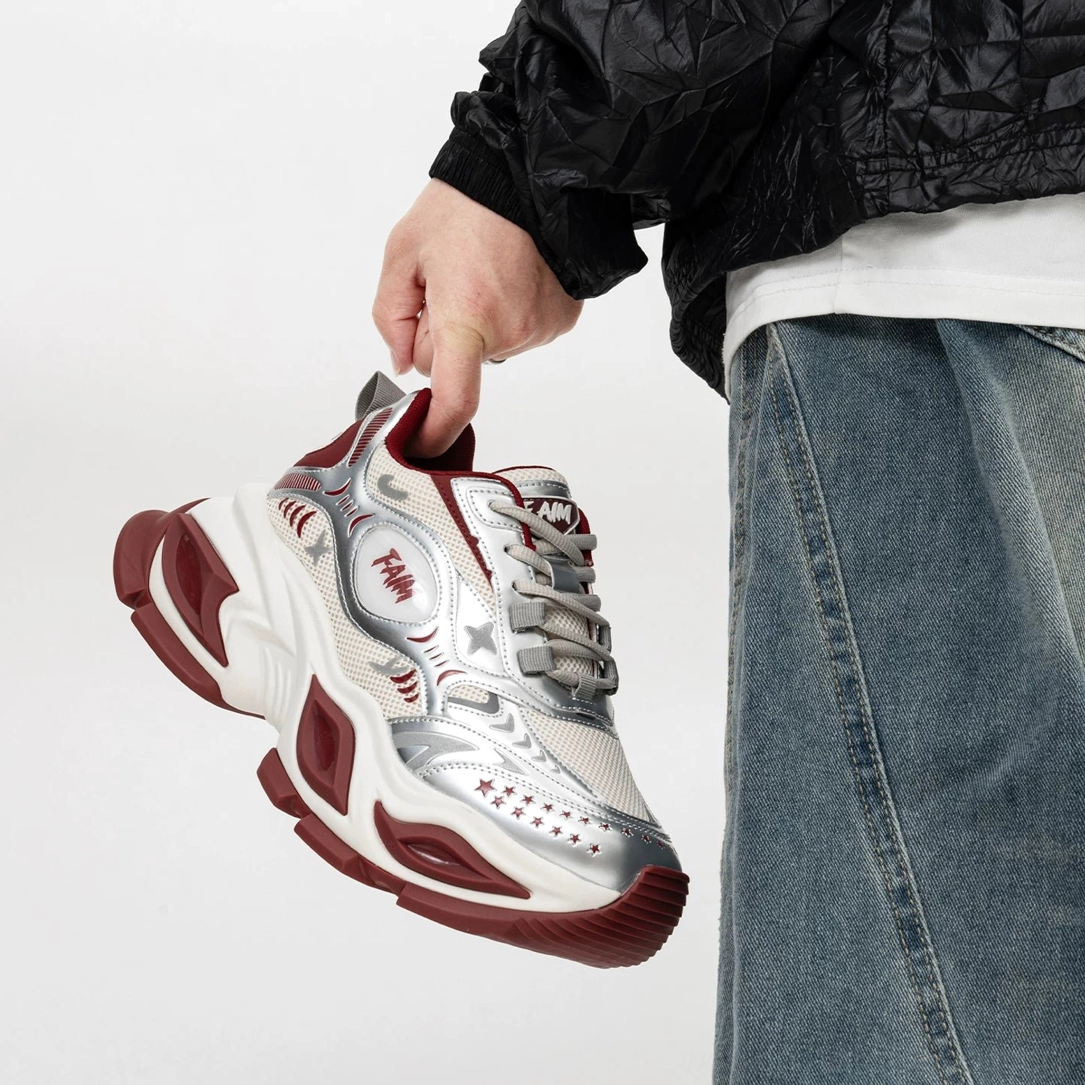 Vibrant red and silver futuristic platform sneaker with bold red outsole, metallic mesh upper, star-inspired side detailing, and oversized streetwear sole