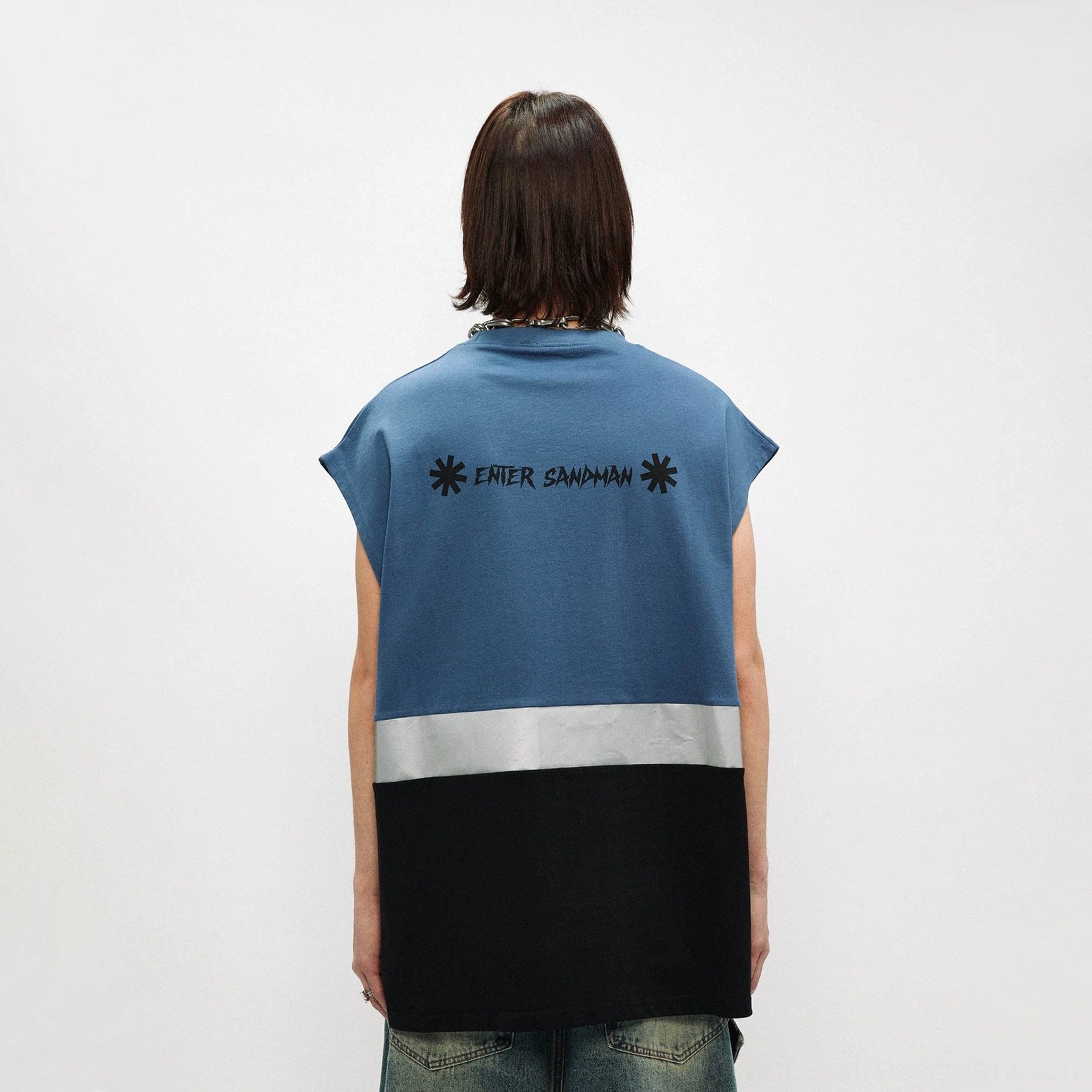 Back view of dusty blue and black oversized gothic graphic tank top with enter sandman lettering