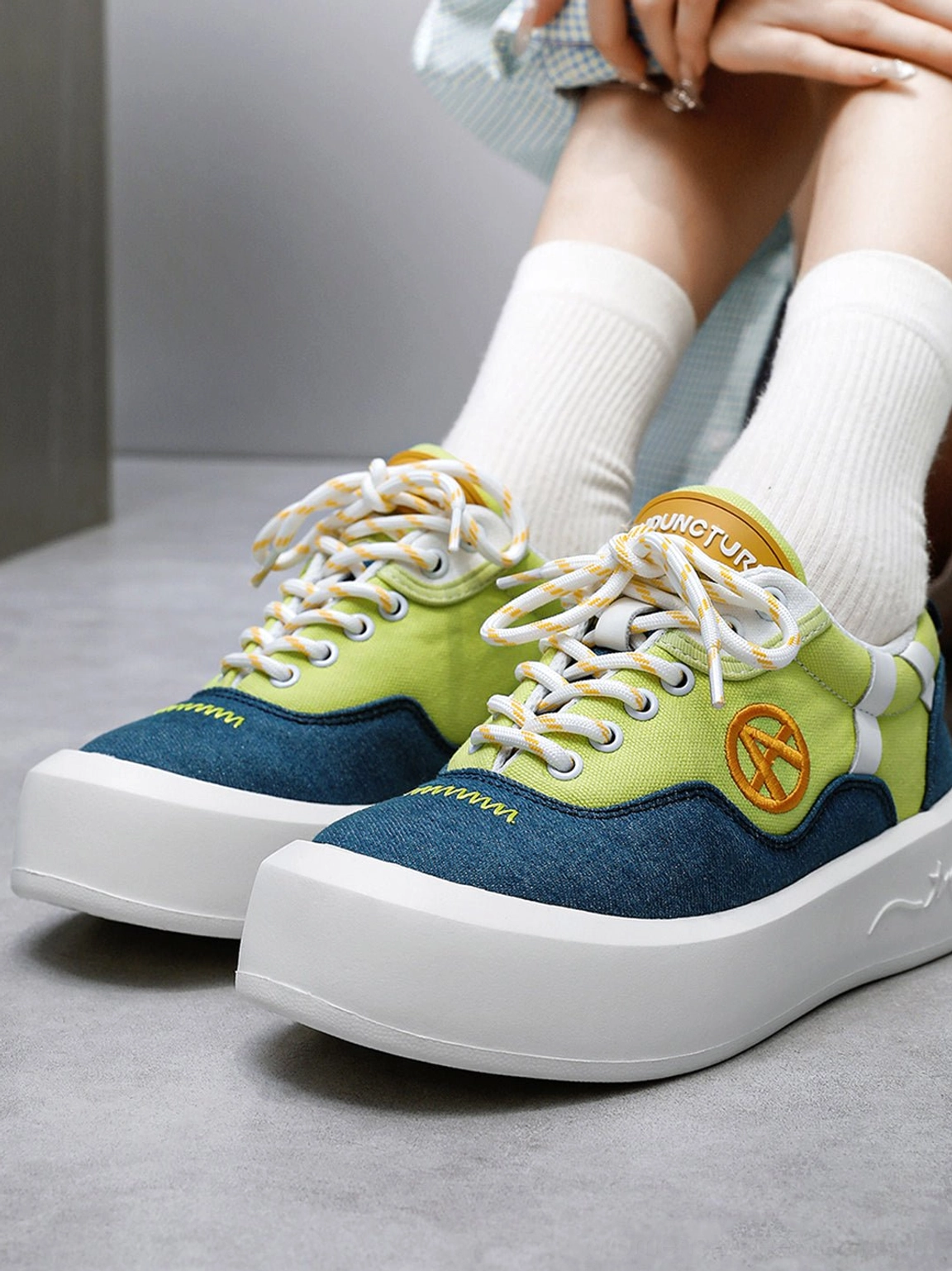 Top view of neon colorblock platform sneakers with yellow laces graphic insole and low-top canvas construction