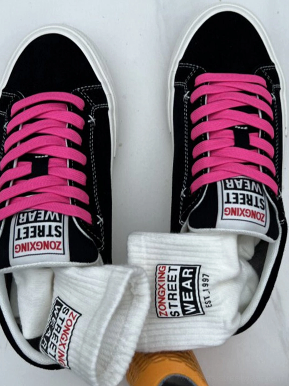 Black suede neon lace platform canvas sneakers displayed with matching crew socks and bold tongue label details