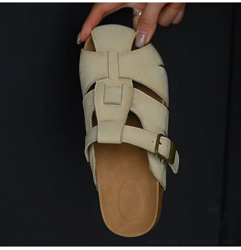 Neutral beige fisherman sandals with adjustable buckle strap, textured cutout leather upper, cushioned insole, and contemporary Acubi-inspired styling