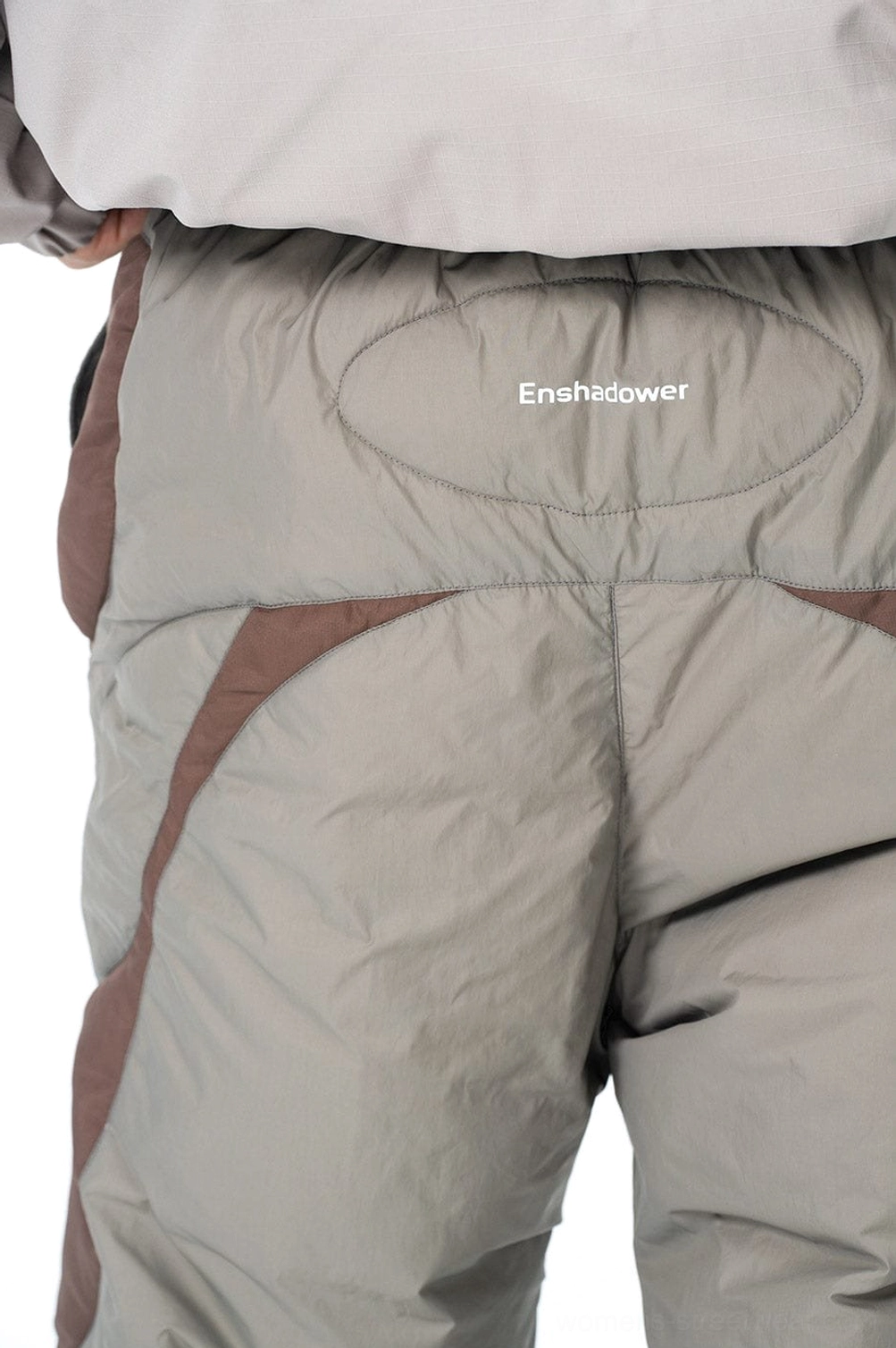 Neutral color-block padded track pants designed for winter layering gorpcore outfits and everyday urban wear