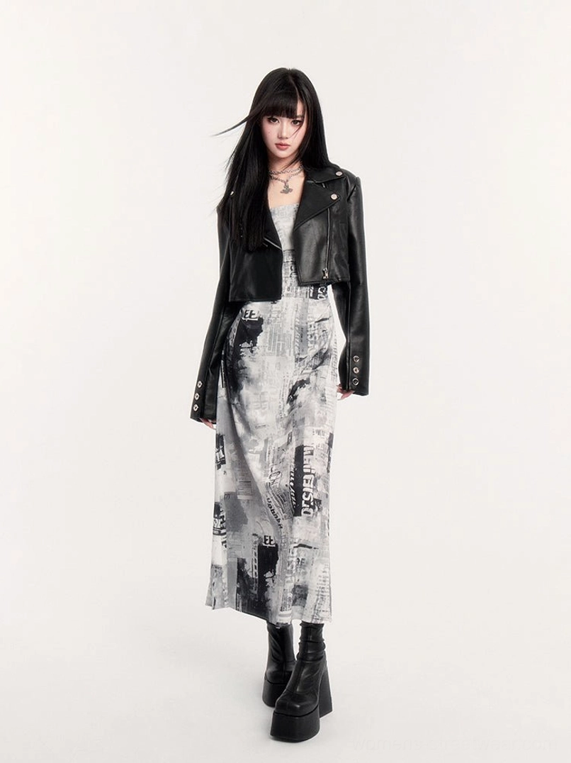 Low angle front view of newspaper print ruched maxi slip dress styled with chunky black platform boots