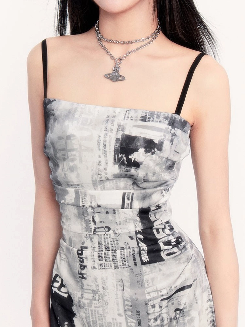 Close up of square neckline, black spaghetti straps, ruched bodice, and vintage newspaper print on slip maxi dress