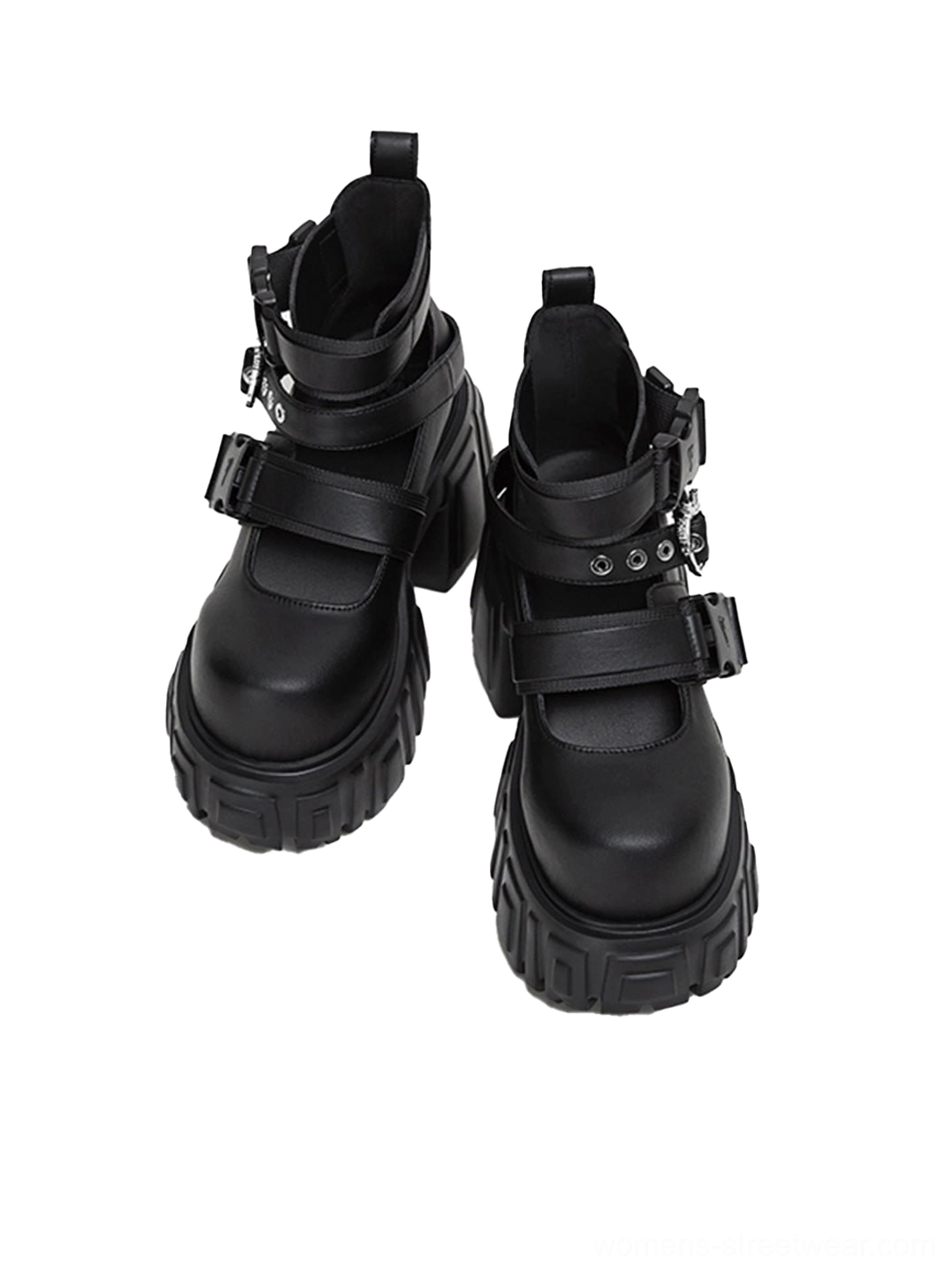 Front view of black platform ankle boots with rounded toe caps, metal buckle details, structured uppers, and chunky block lug heels