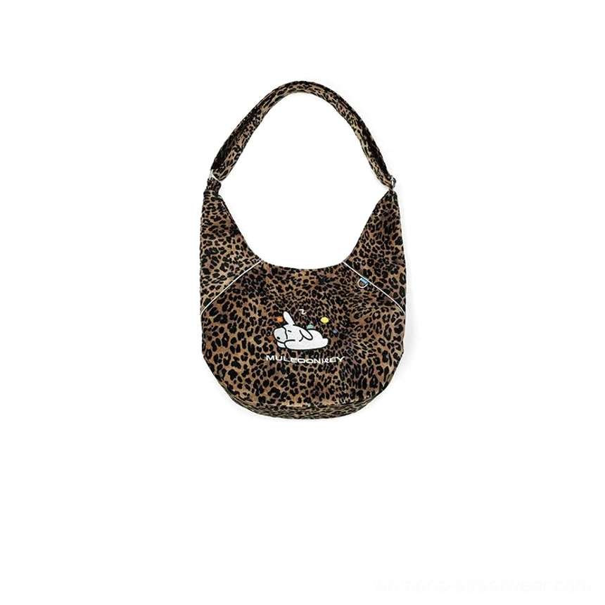 Leopard print utility sling hobo crossbody bag with matching adjustable shoulder strap and playful streetwear design
