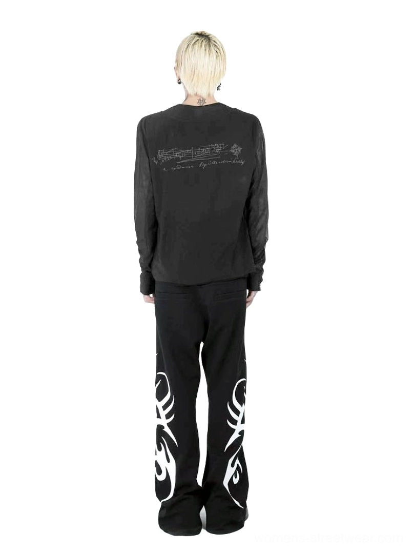 Back view of black goth music note long sleeve top with handwritten staff print and layered hem