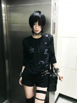 Black nocturne staff star layered goth mesh long sleeve top worn in a subway elevator front view