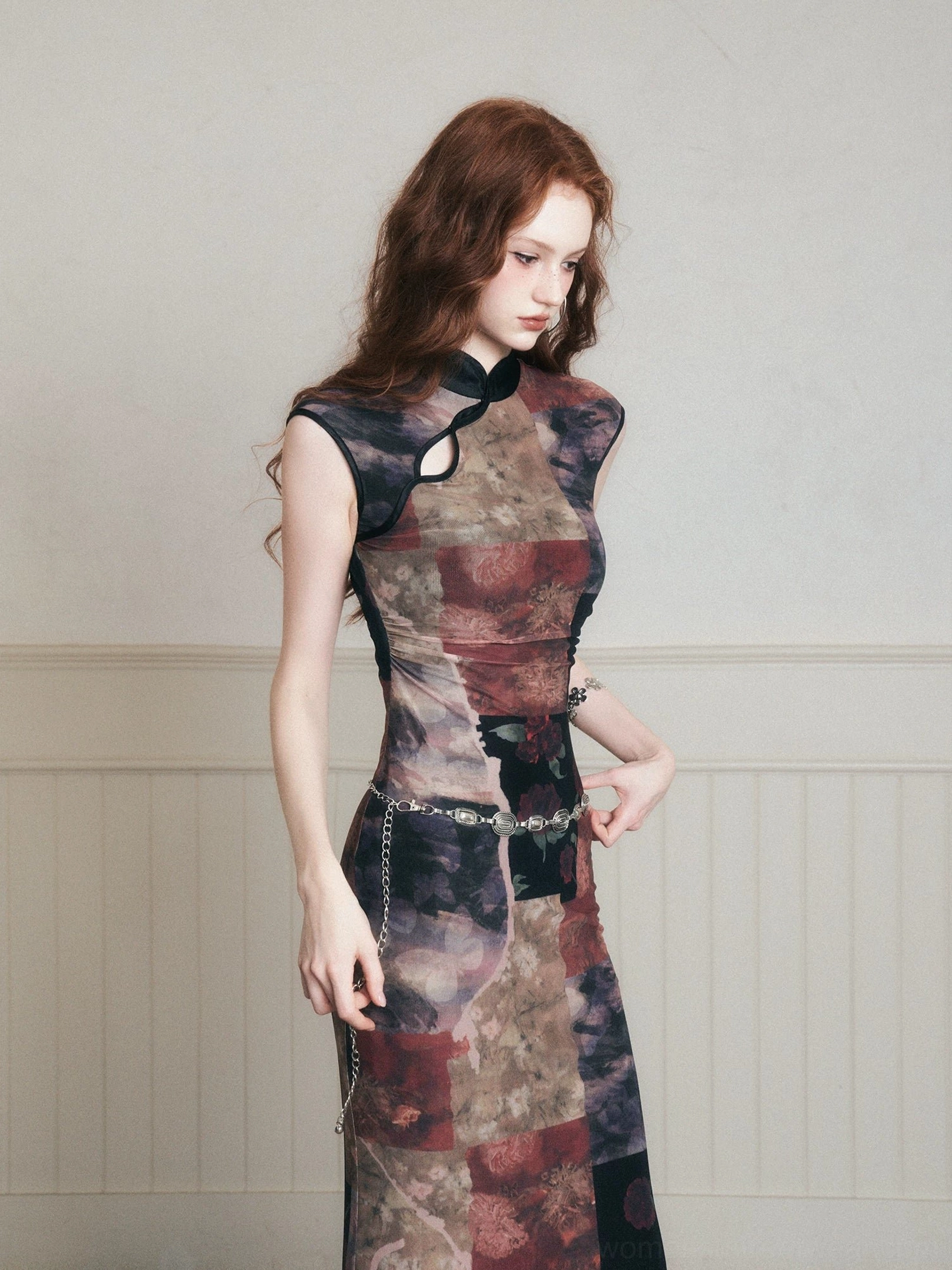 Close front view of noir patchwork qipao-inspired maxi dress showing high collar shoulder keyhole and floral collage print
