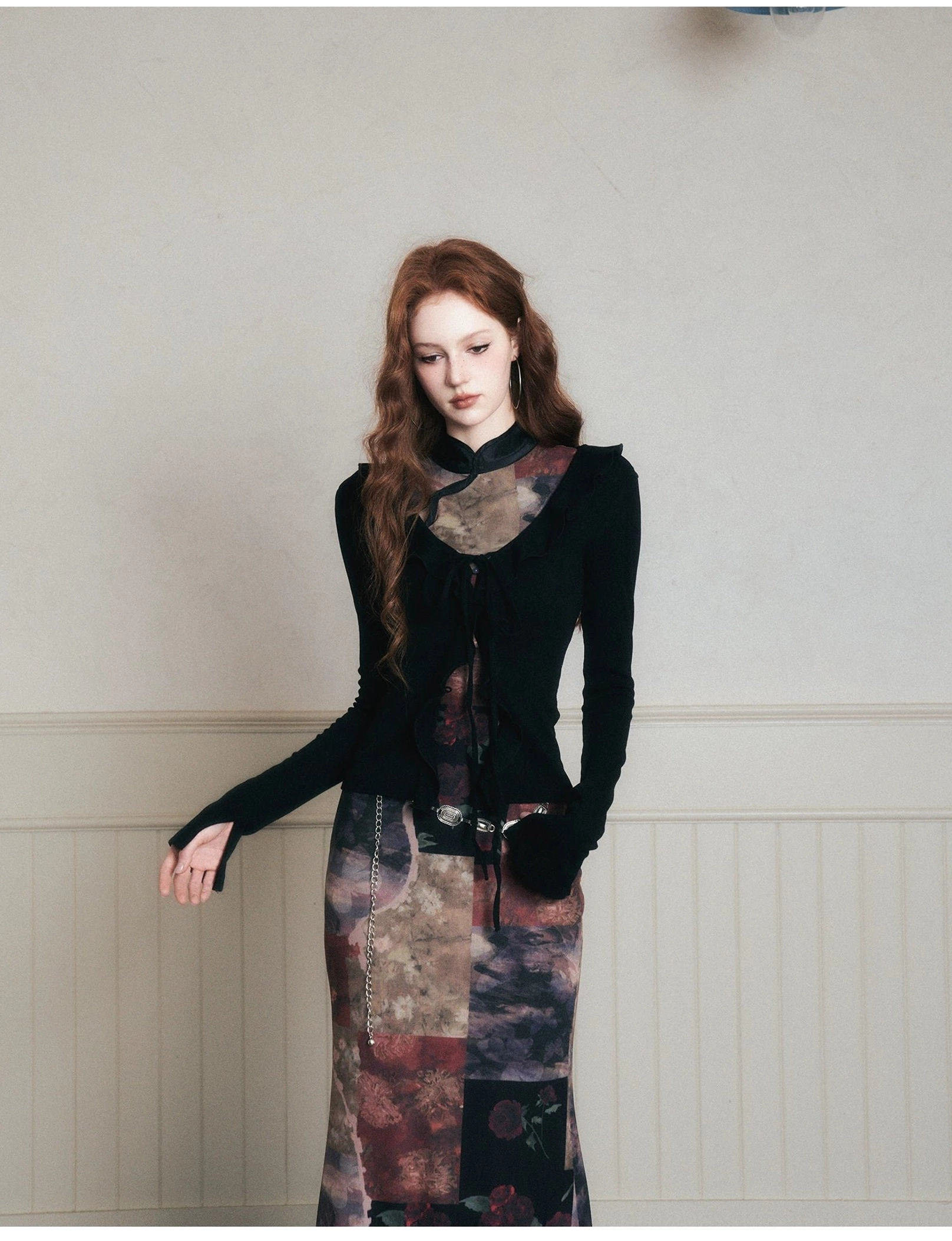 Three-quarter styling reference of a noir velvet top and dark patchwork maxi skirt with asymmetrical details
