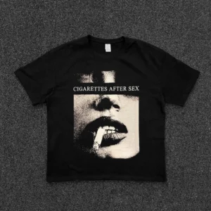 Black Noir Reverie halftone band graphic tee with vintage smoking lips portrait print and relaxed cropped streetwear silhouette shown in a flat lay