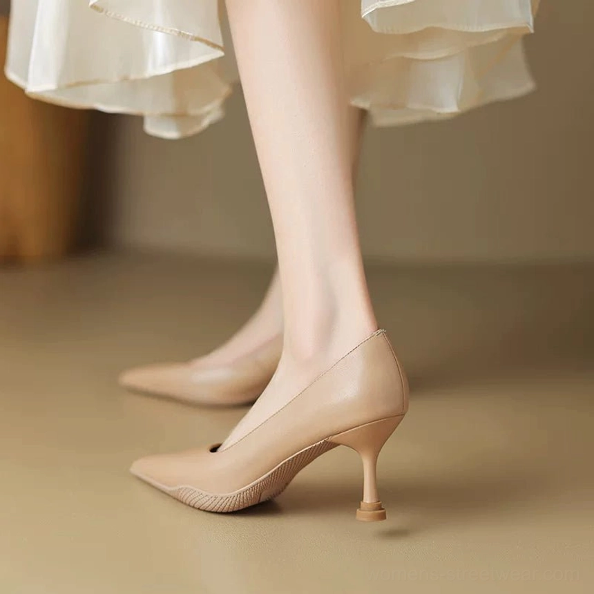 Nude pointed-toe kitten heel pumps with mesh vamp and slender tapered heel close-up