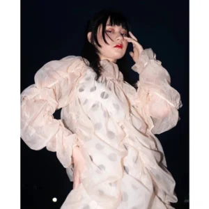 Front close-up of a nude sheer polka dot ruffle midi dress with gathered texture, oversized puff sleeves, and an avant-garde streetwear silhouette on an East Asian model