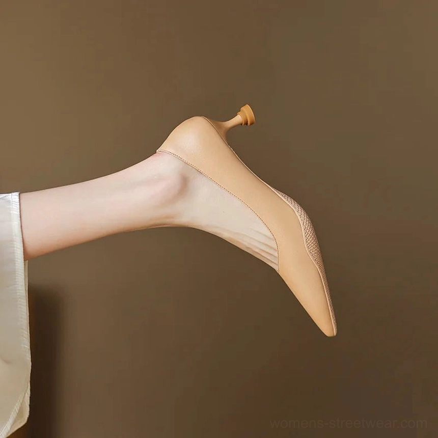 Nude soft leather pointed-toe kitten heel pump with mesh vamp against a neutral background